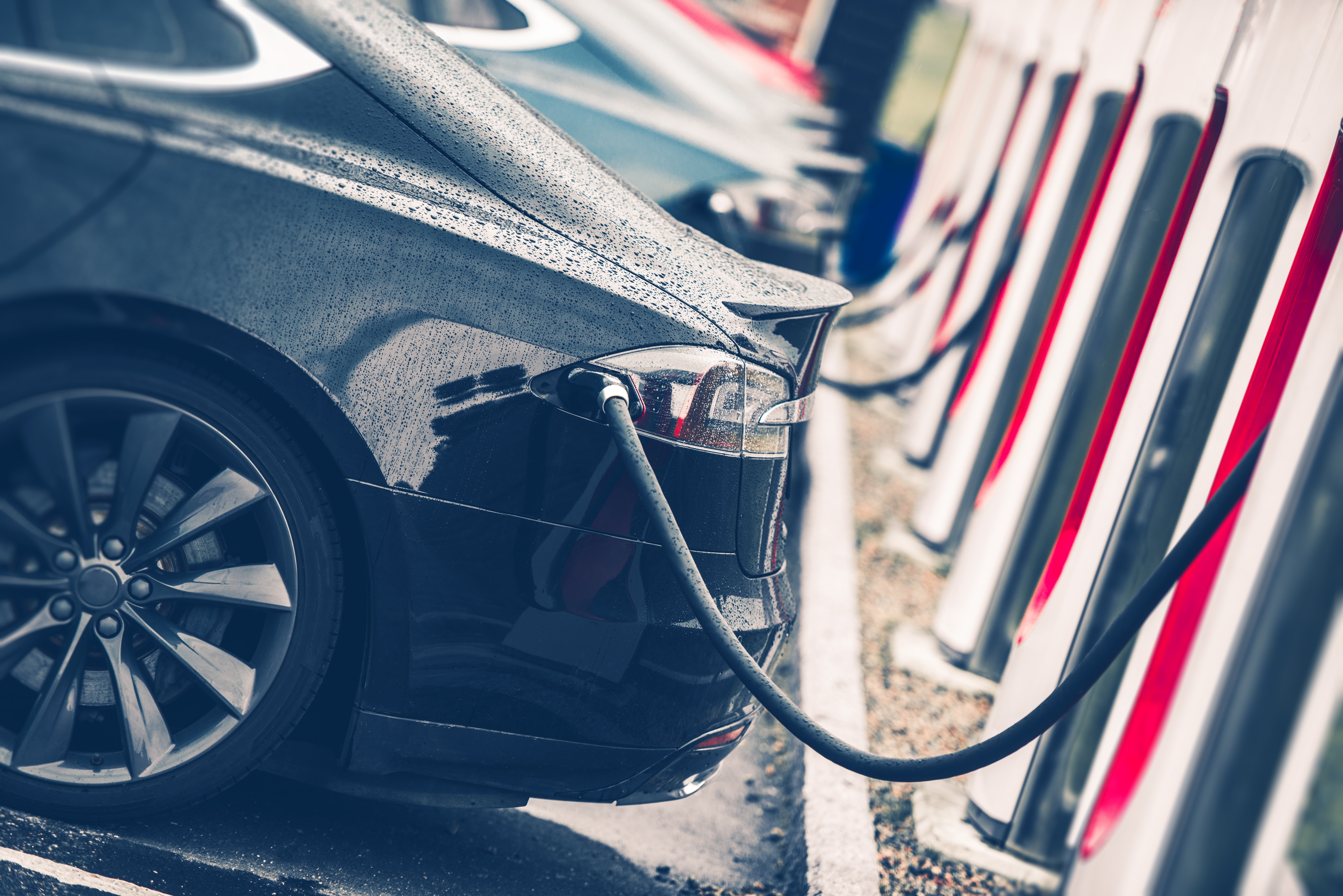Electric Cars Charging Station Closeup Photo. Vehicle Rechargeable Batteries Charing. Future of Transportation.